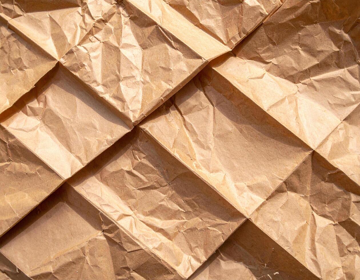 Crumpled paper background with a square pattern photo