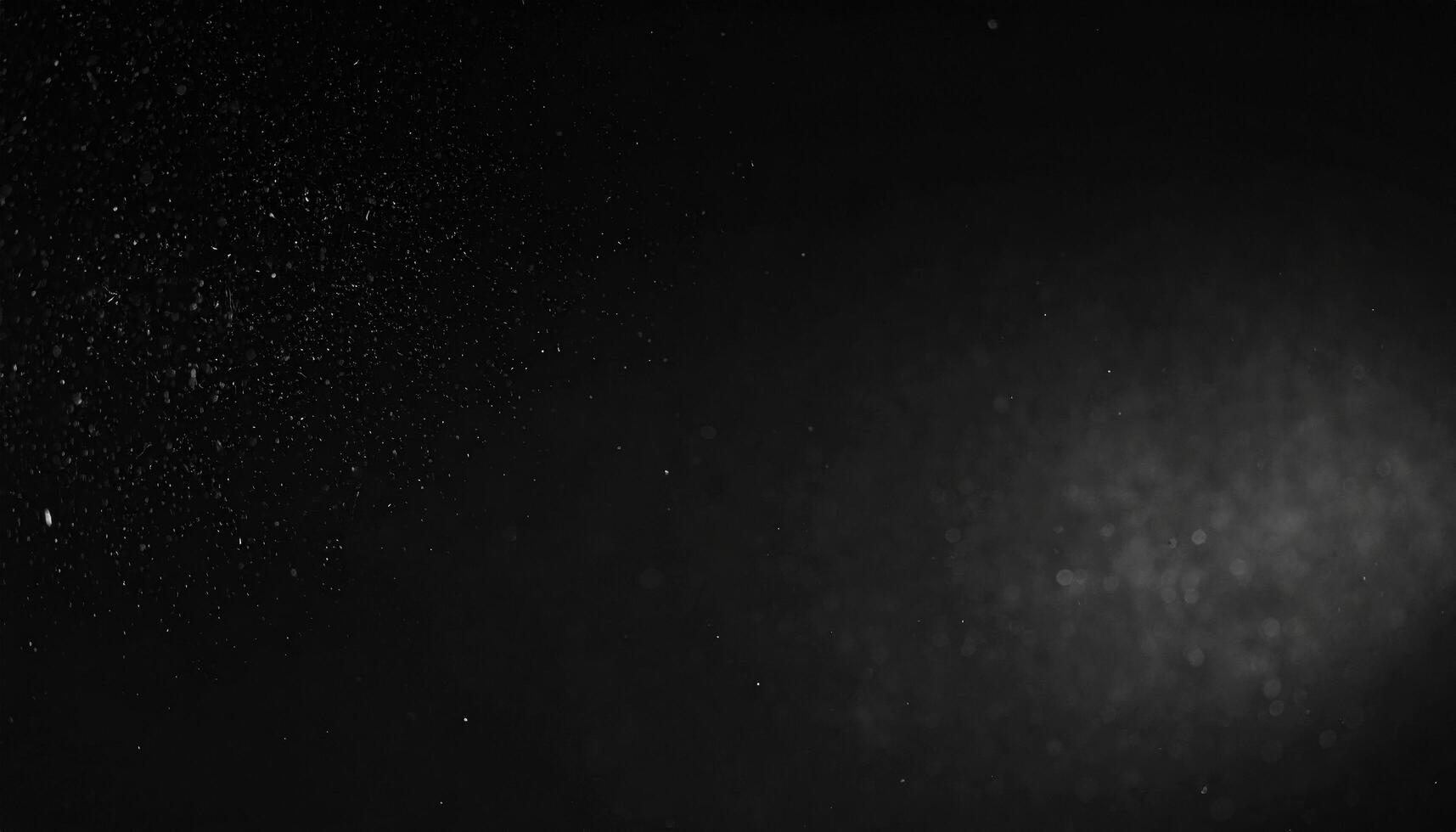 Dark background showcases mesmerizing display of fine particles suspended air, creating sense of depth and mystery. subtle interplay of light and shadow enhances ethereal quality of scene photo