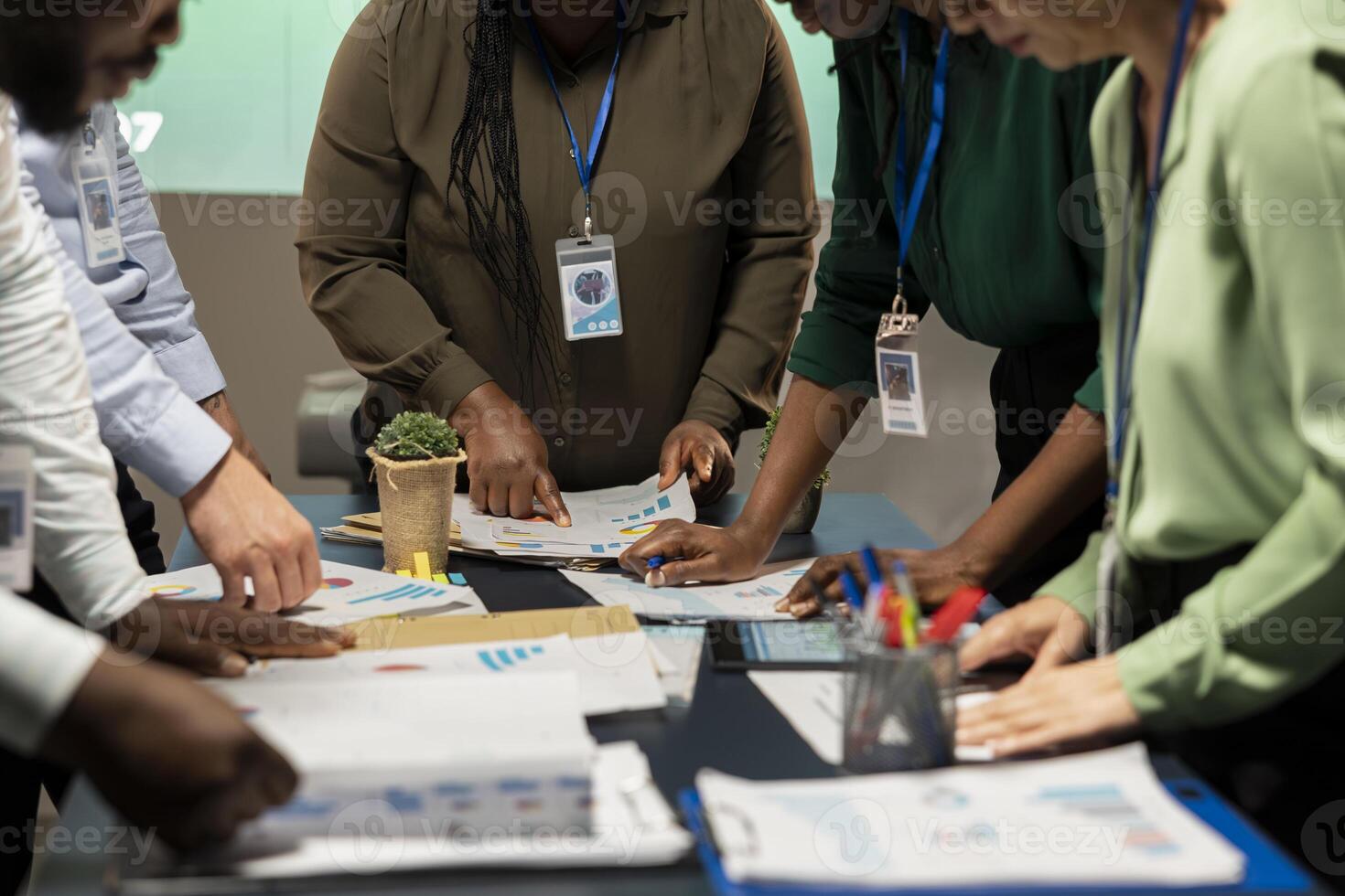 Business consultants team meeting after hours to review diagrams and assess risks, exchanging feedback and collaborating on insights backed by business intel. Forecasting predictions. photo