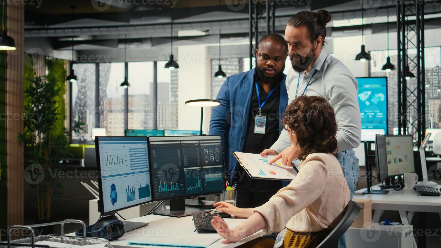 Diverse corporate staff working together on report writing in the office, collaborating on building a new development strategy. Reviewing insights to enhance efficiency and progress. photo