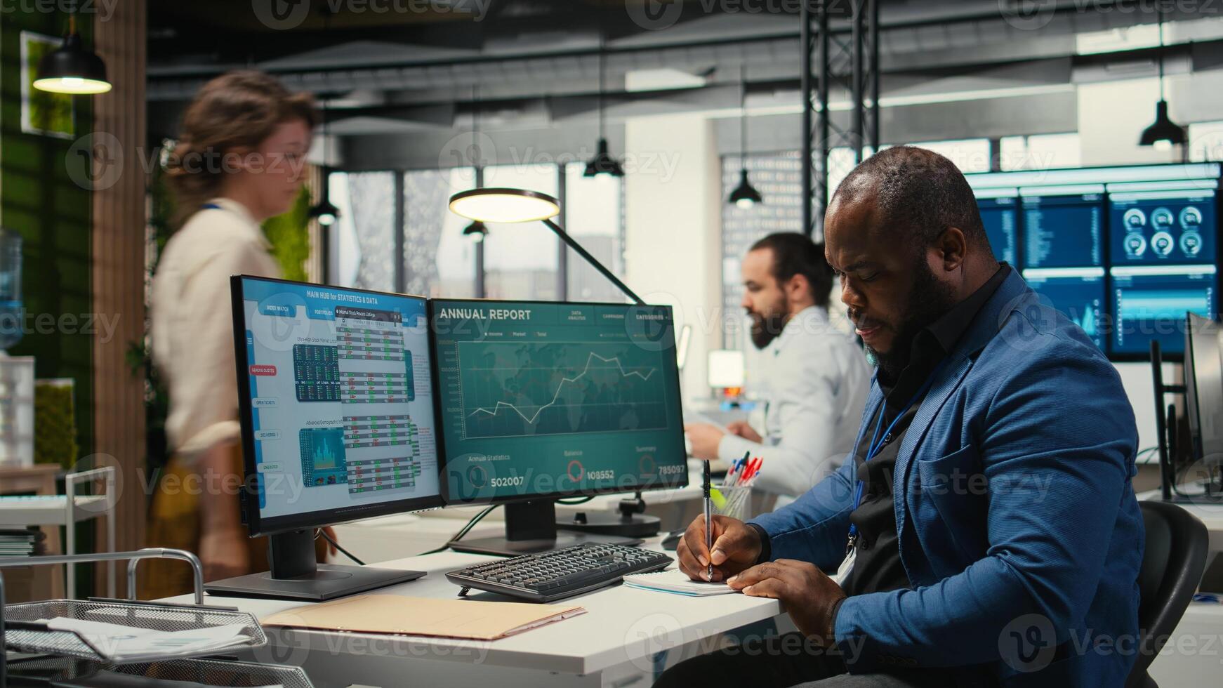 Black employee building new development strategy with notes, analyzing data and solutions to forecast project outcomes. Male professional working on briefing reports in the office. photo