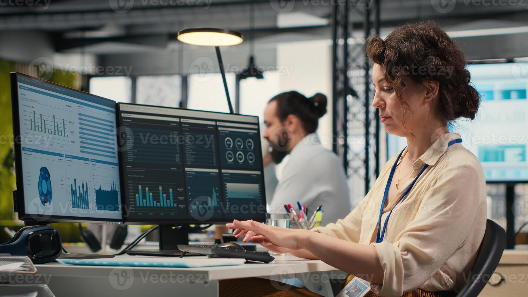 Administrator engages with financial data insights on a computer, developing innovative business solutions and aligning project goals with company objectives. Corporate environment. photo