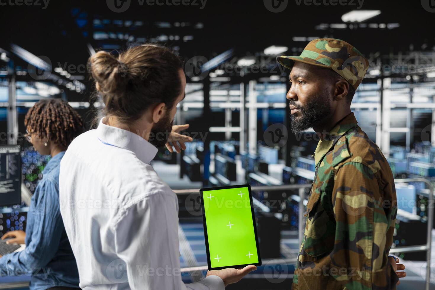 Army tech soldier and engineers using green screen on tablet, troubleshooting computer systems for a national defense military mission. Officer and server farm admins on industrial platform. photo