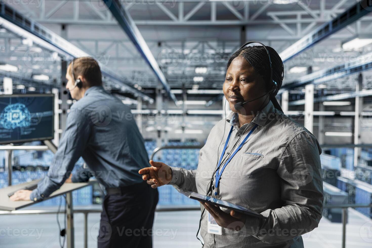 Data center admins conducting remote diagnostics with headset communication. Server hub coworkers interpreting artificial intelligence generated logs on tablet to resolve user issues photo