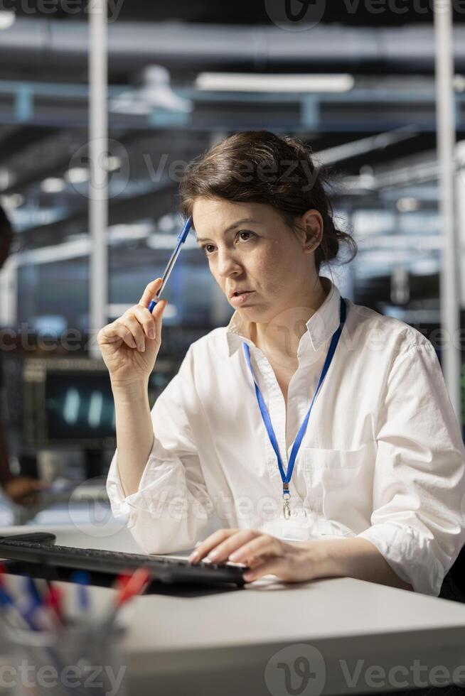 Data center technician doing brainstorming on how to fix gear, doing maintenance tasks. Server farm employee thinking how to repair network rigs after conducting system checks photo