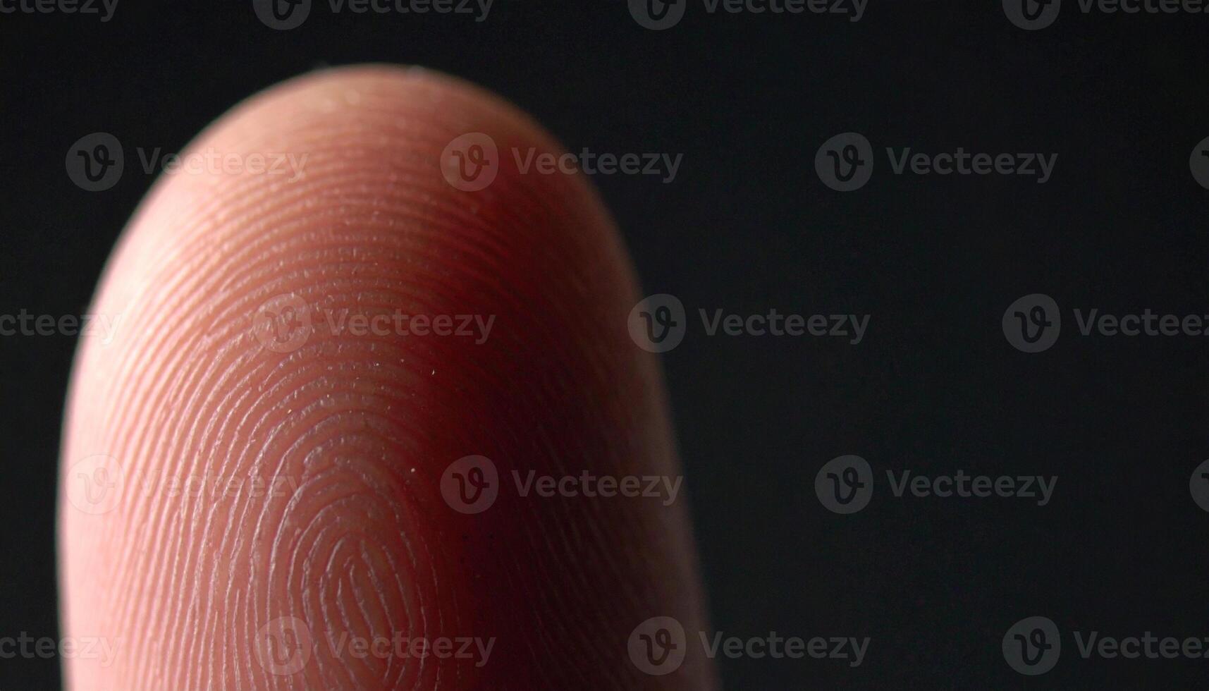 Macro photo of human fingerprint detail with dramatic lighting, highlighting biometric identity, security concept, unique skin pattern, forensic texture, and technology close up.