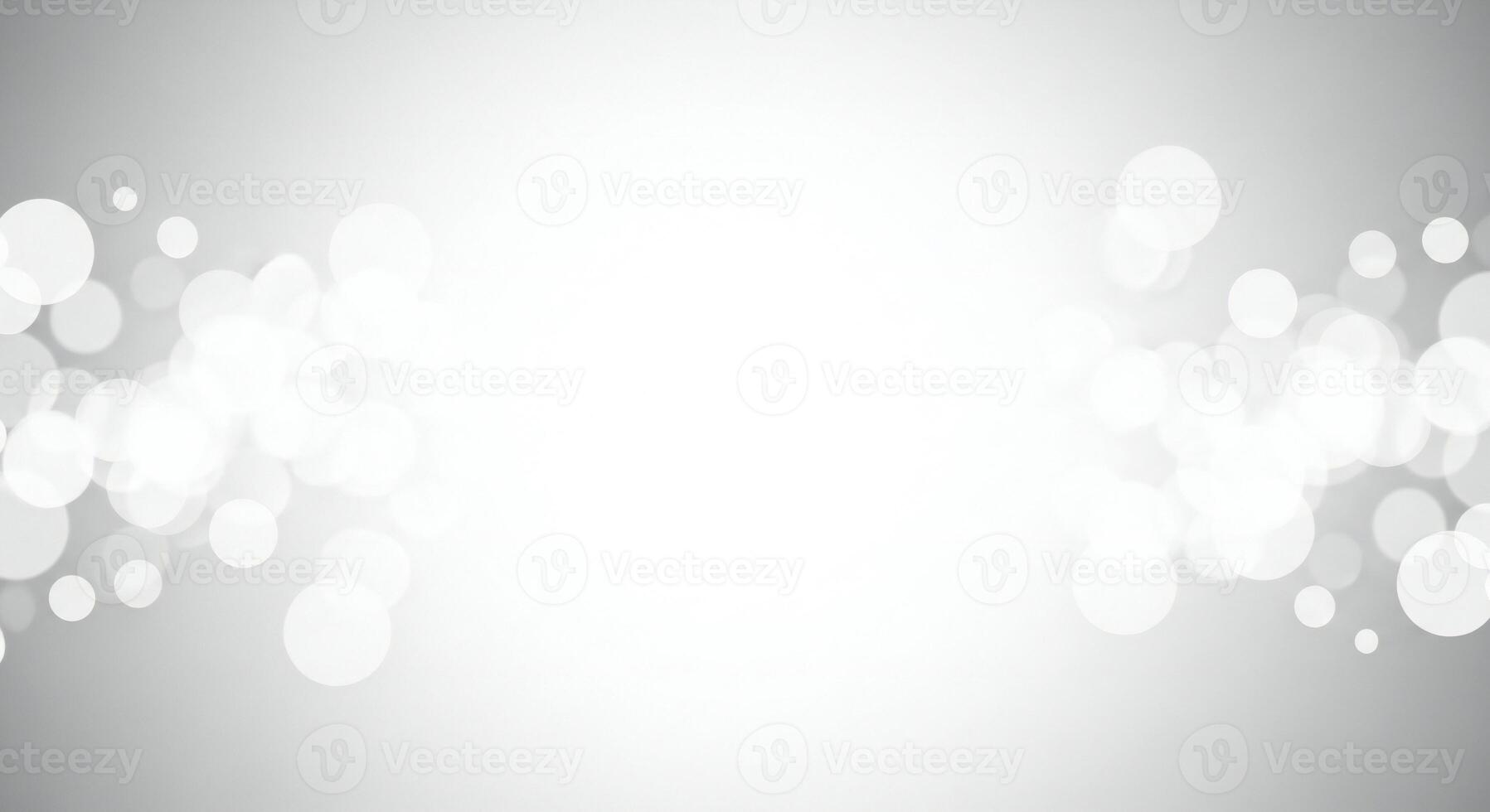 Soft focus white bokeh lights on a subtle gray gradient background abstract photo