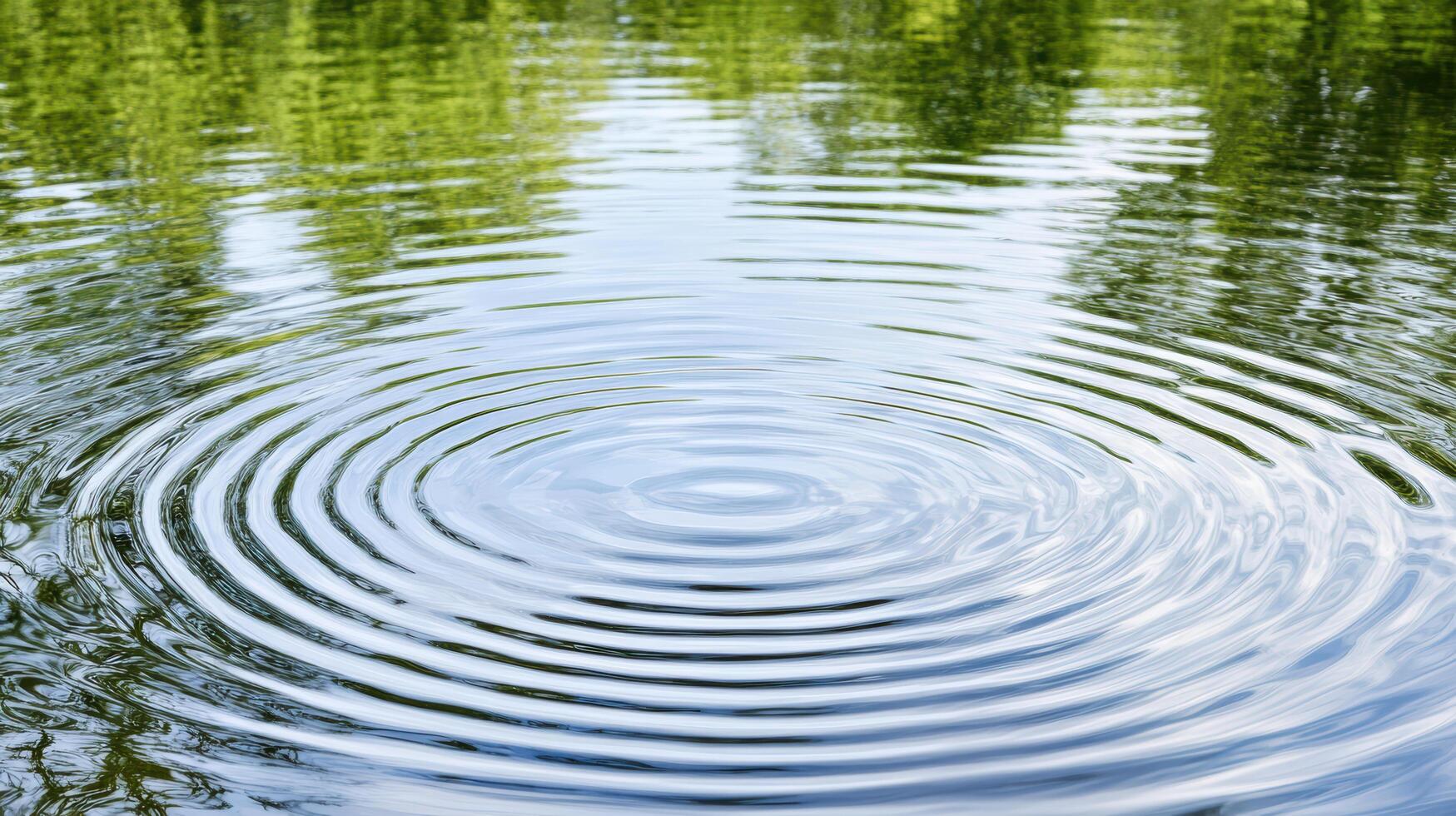 Rippling water surface reflects greenery, creating serene and calming atmosphere photo
