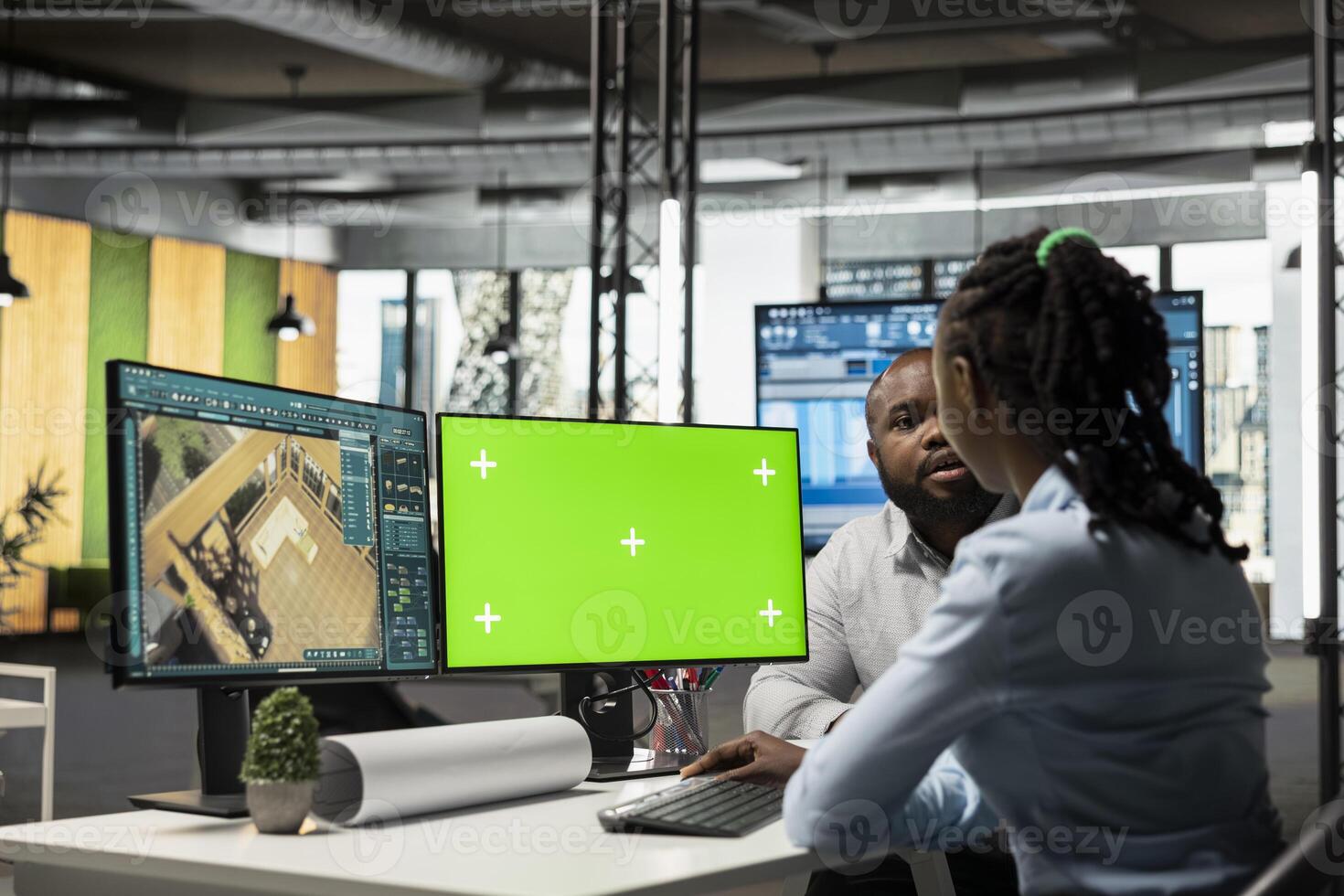 Black developers team preparing apartment building layout next to mockup screen, working at desk with dual monitors to design residential area after the construction project. Decorations software. photo