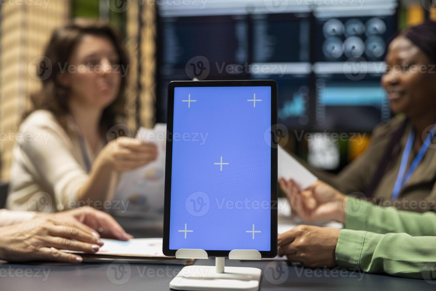 Diverse associates setting objectives with copy space display on tablet, empowering women creating projects through visuals, data driven planning and corporate innovation for growth. photo