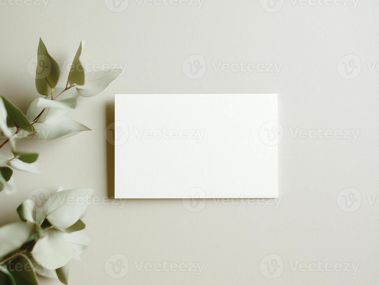 Elegant boho invitation card mockup with greenery on soft textured surface photo
