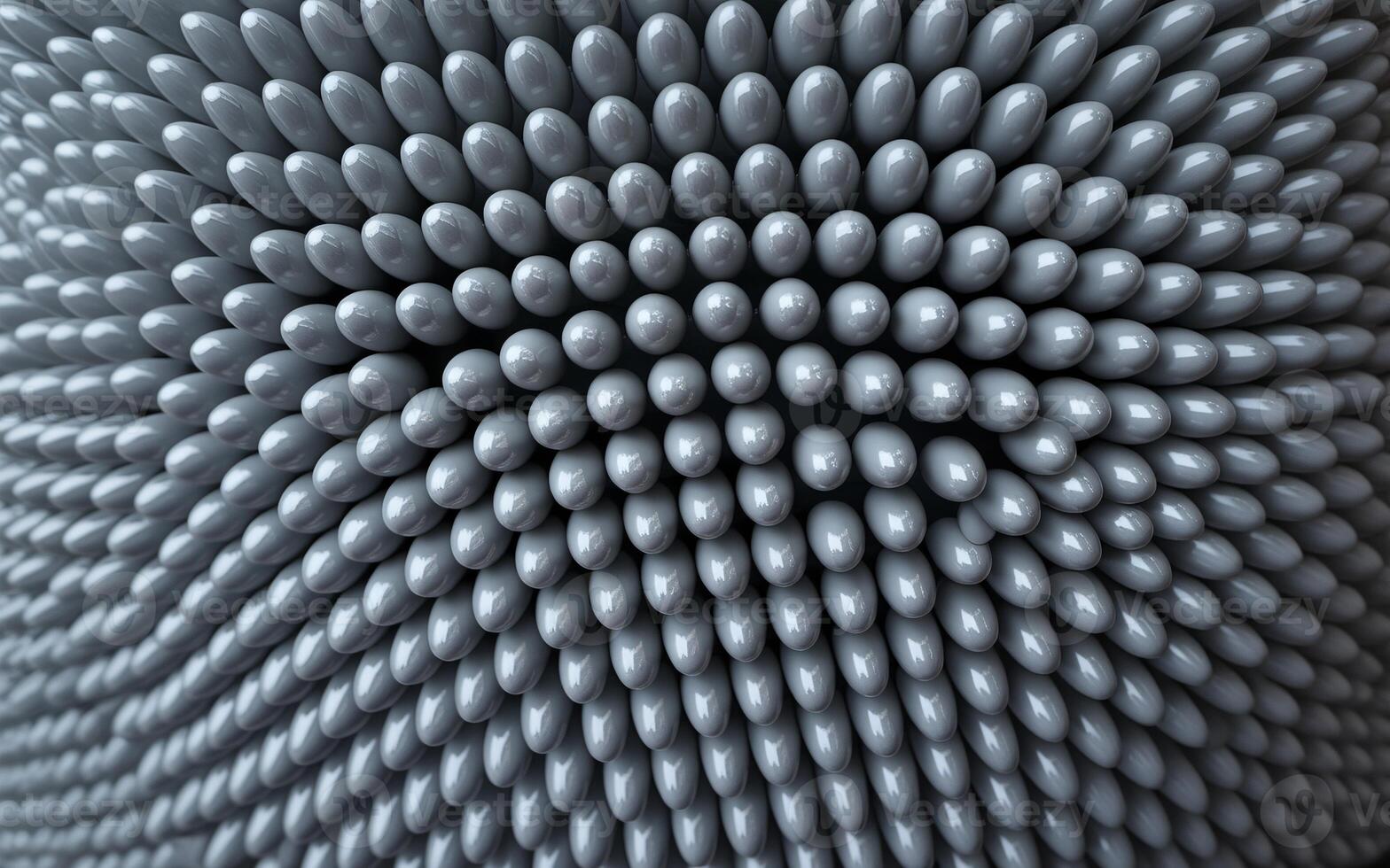 Close-up of a textured surface made of numerous interlocking gray spheres, creating a mesmerizing pattern. photo