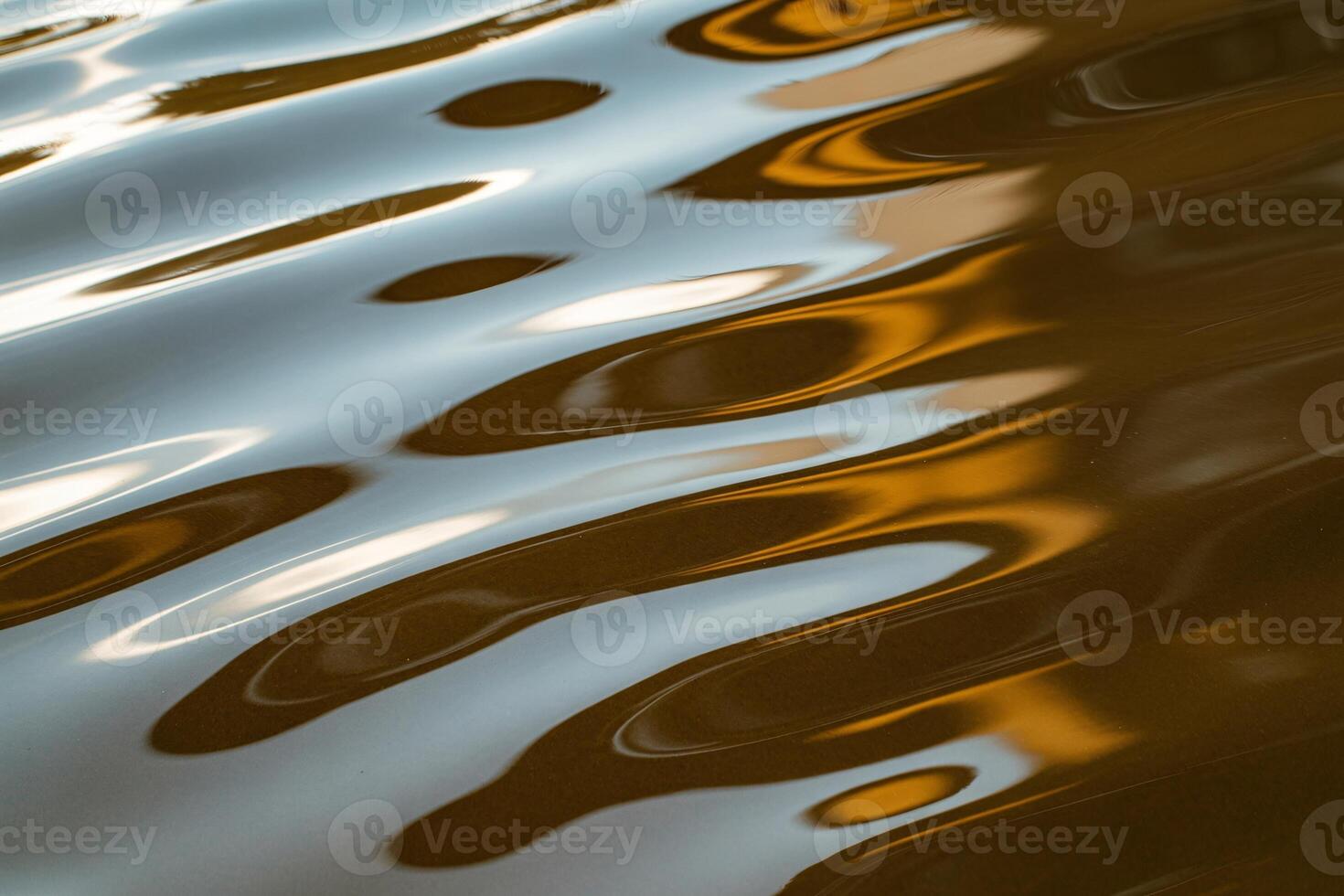 Reflections in serene water create a mesmerizing pattern of light and color. photo