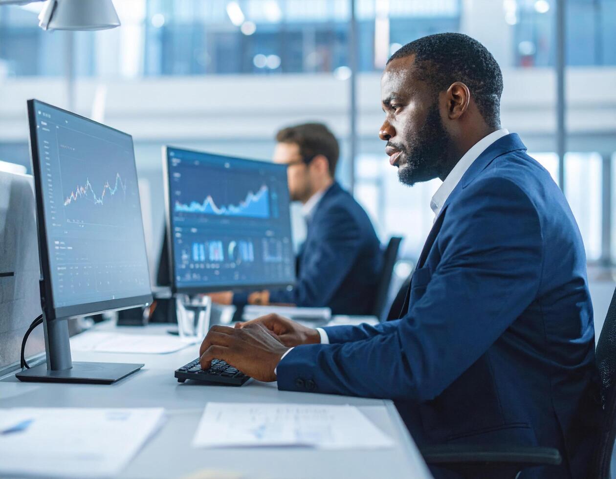 Young businessman in office working on computer, focused on data analysis and financial graphs, showcasing professionalism and dedication photo