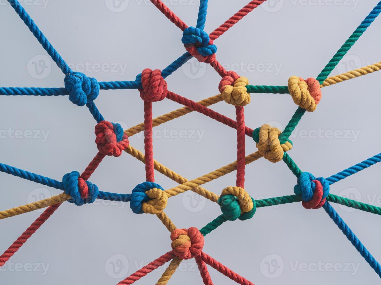 A colorful arrangement of ropes in various knots creating an intricate geometric pattern. photo