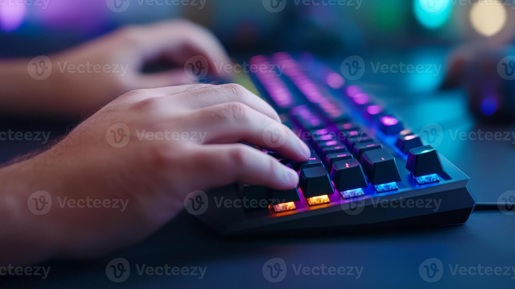 Vibrant close-up of hands typing on a mechanical keyboard in a modern gaming setup at night with colorful LED lights photo