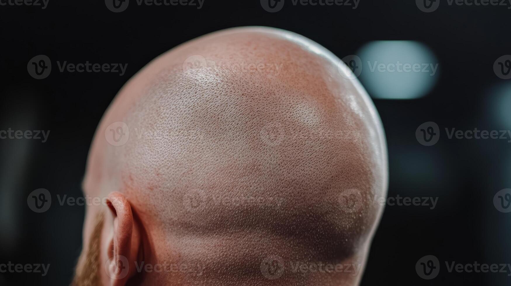 Shaved head with precise scalp micropigmentation under studio lighting in a barbershop setting photo