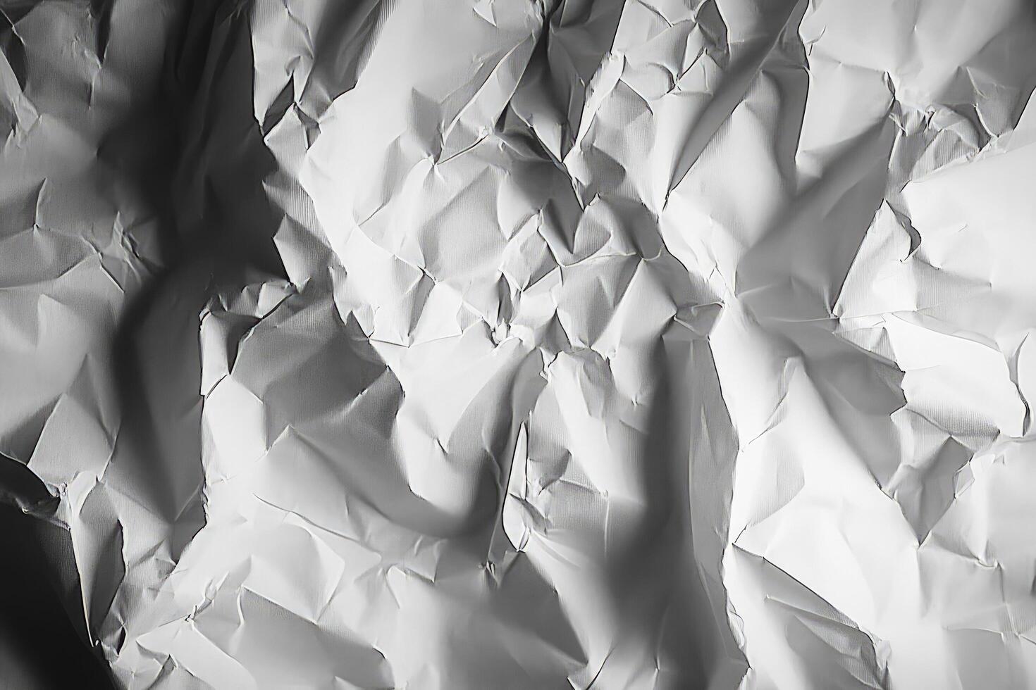 Abstract pattern with crumpled white paper showing shadows and highlights across the uneven surface photo