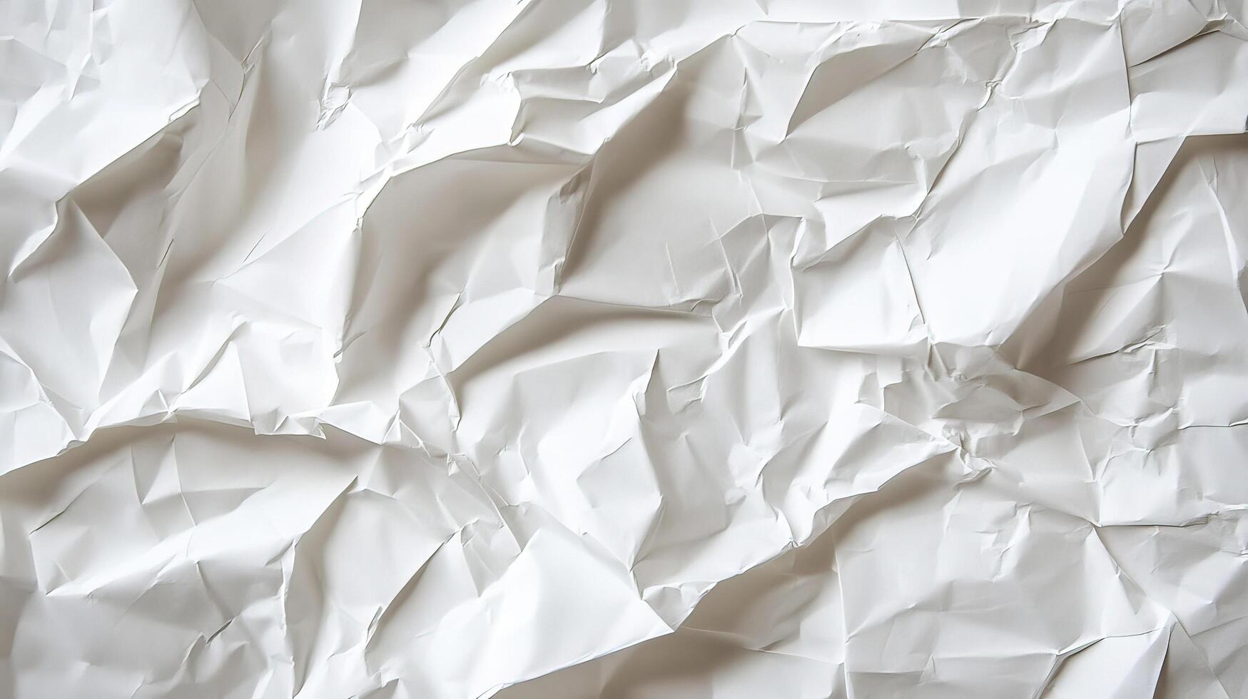 White crumpled paper with deep shadows showcases an intricate and abstract textured pattern photo