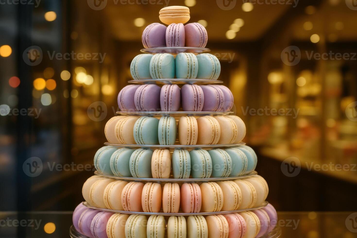 Meticulously arranged pyramid of colorful macarons in a high end sweets store window display photo