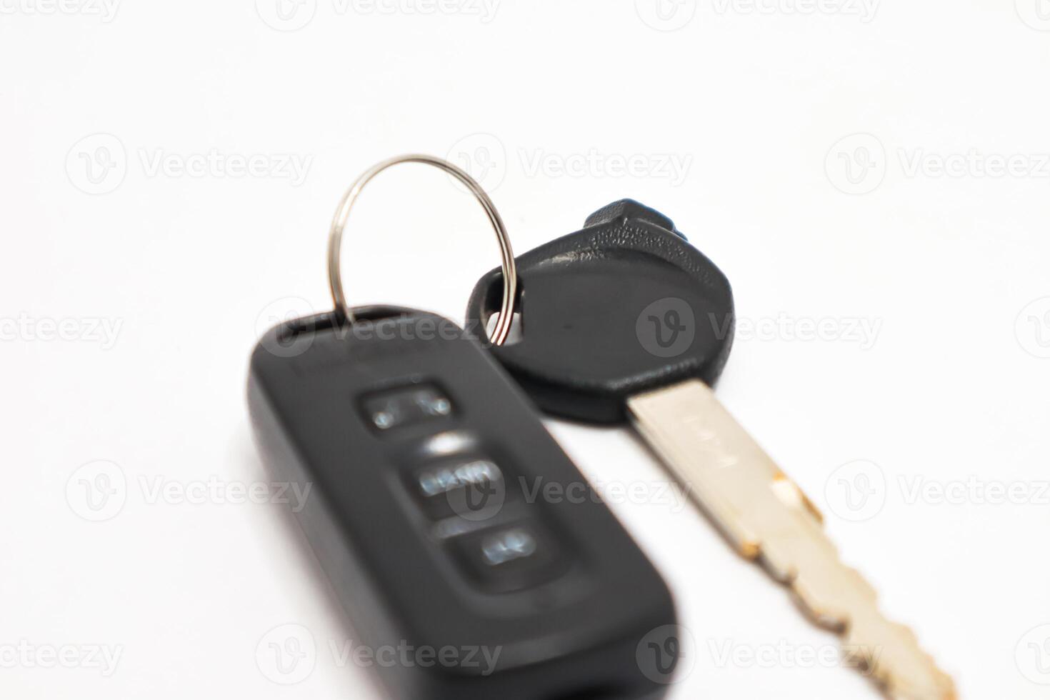 Modern car key with remote on a white background, representing vehicle security and access photo