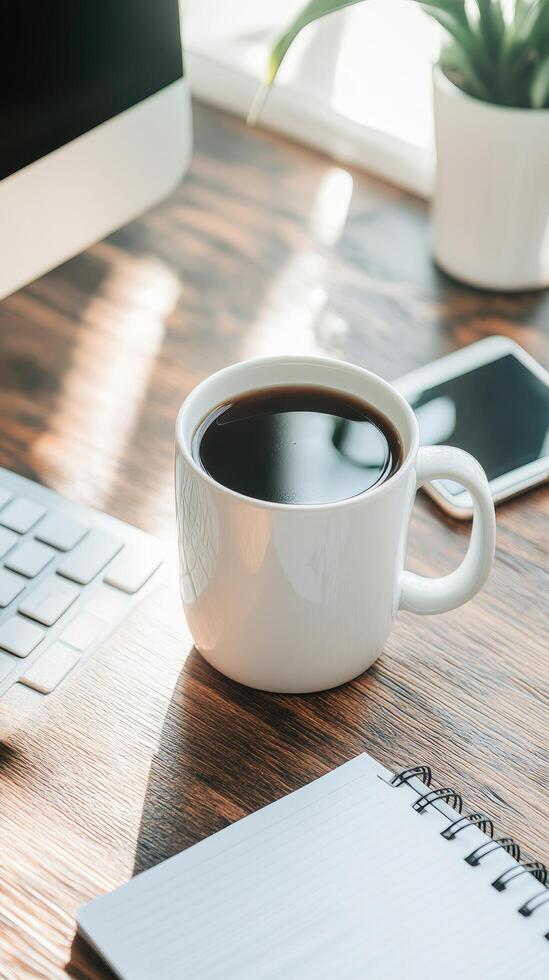 Office desk coffee and workspace scene with computer keyboard and notebook in natural sunlight photo