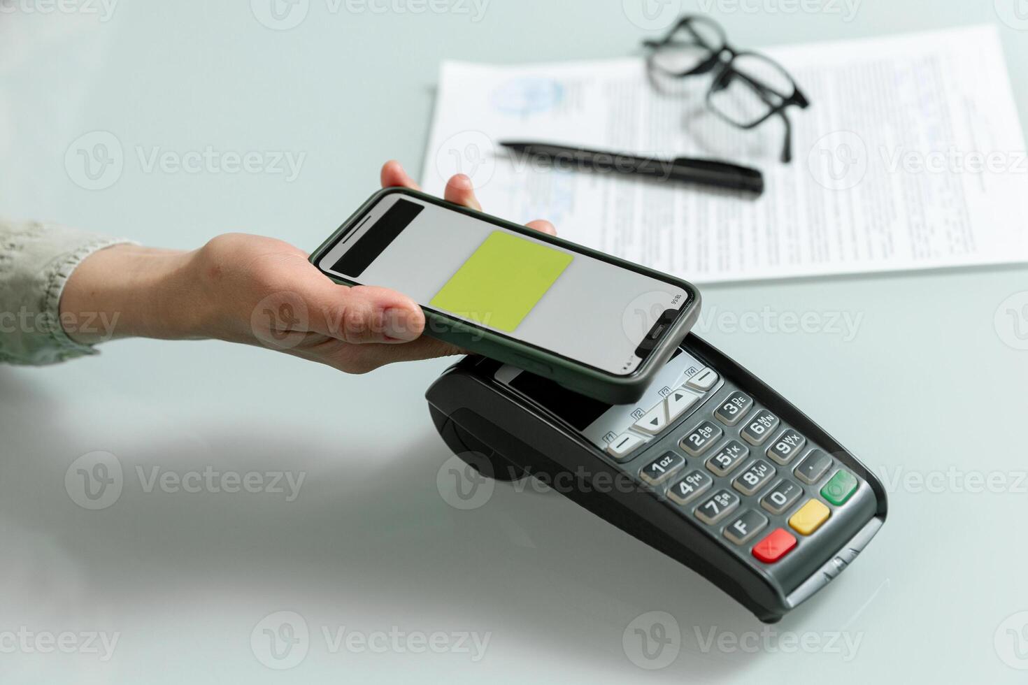 Hands using pos terminal and smart phone to complete nfc payment, financinal operation. photo