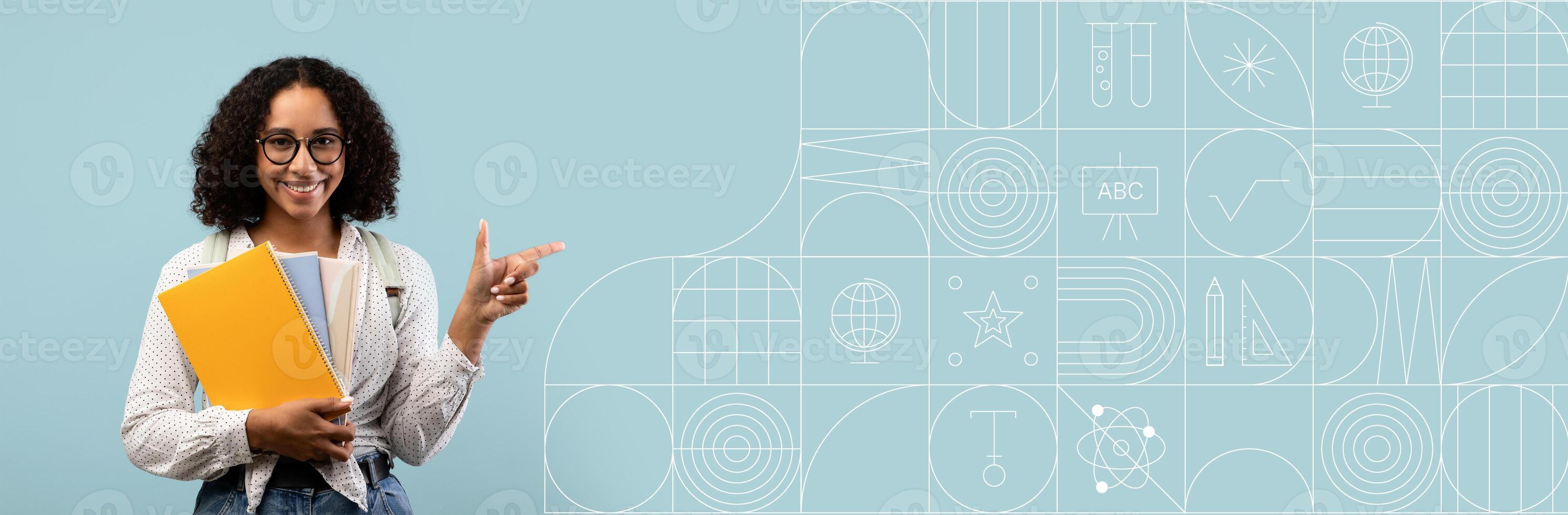 A student stands, holding colorful folders, smiling and pointing while surrounded by a painted background. This atmosphere emphasizes a positive learning environment perfect for educational themes. photo