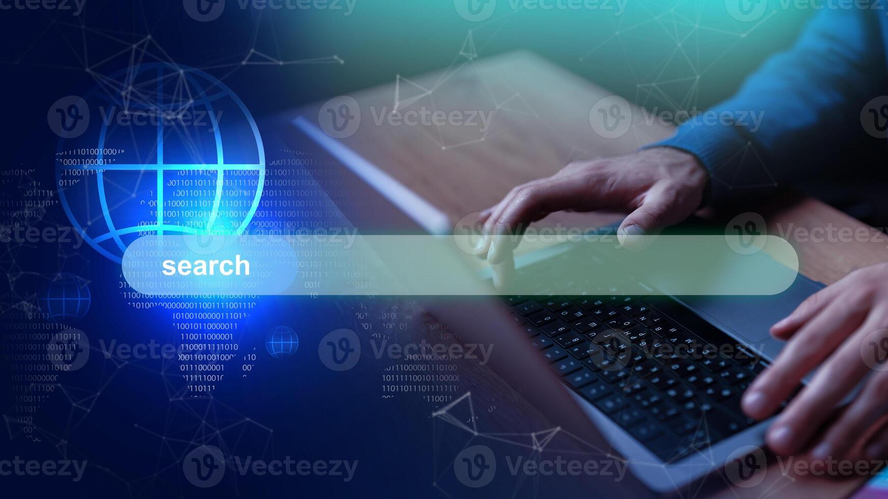 User typing on a laptop with a digital interface displaying a search bar and data visualization photo