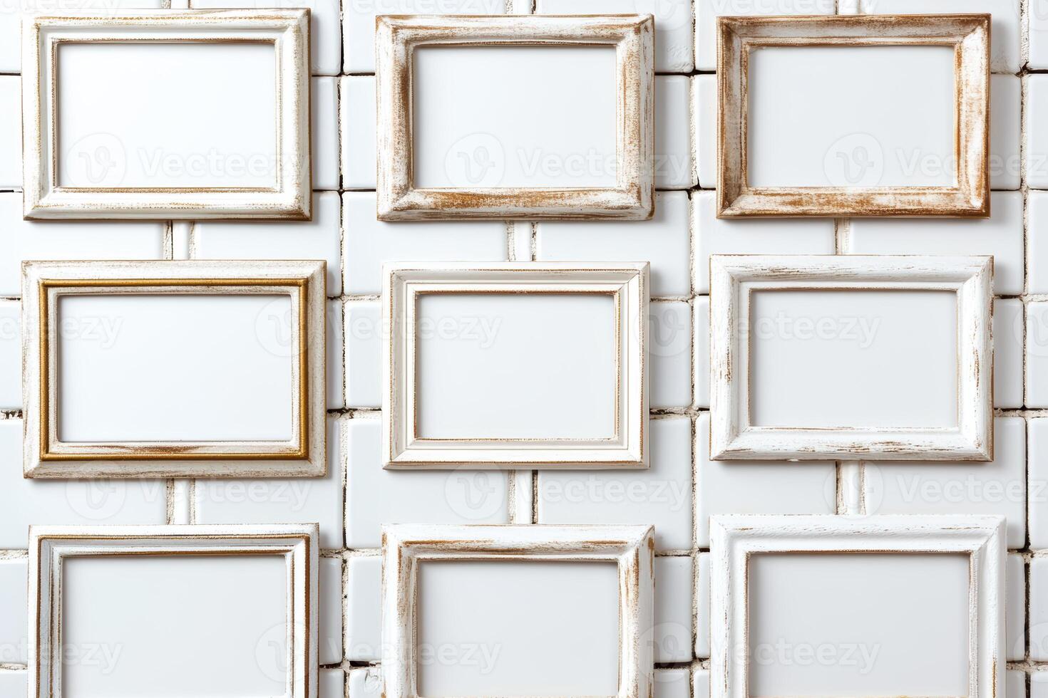 Empty picture frames arranged on a white tiled wall in a creative display photo