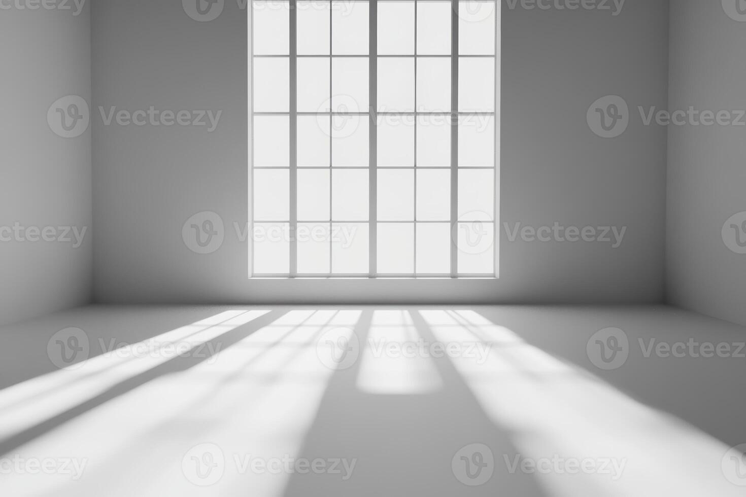Sunlight streaming through a large window in a minimalist room with shadows on the floor photo