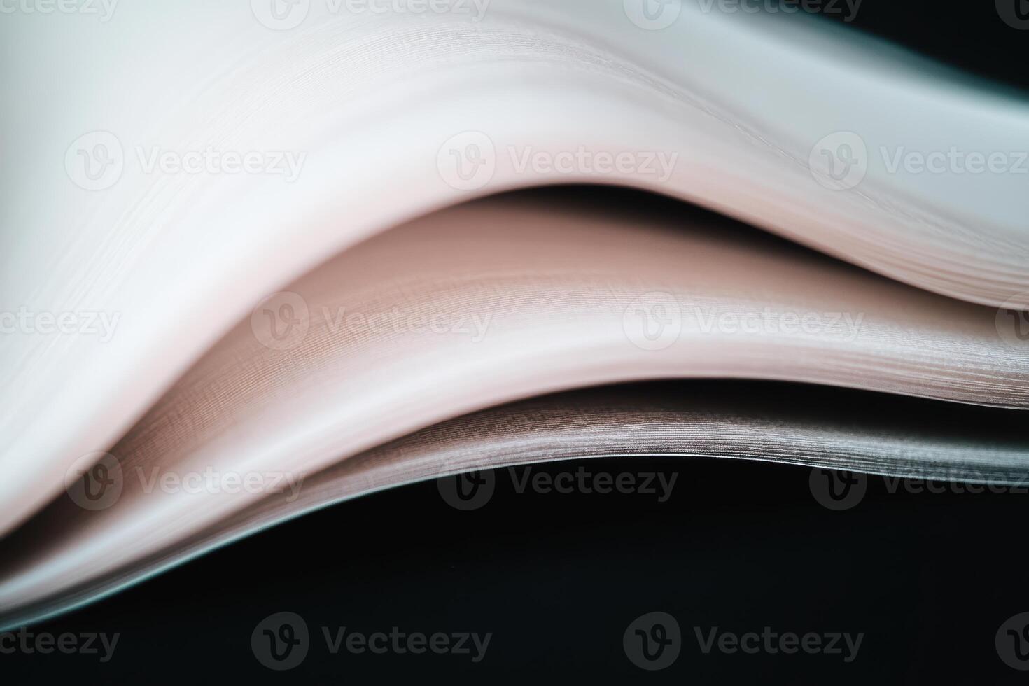 Curved pages of an open book create a dynamic sense of motion and texture photo