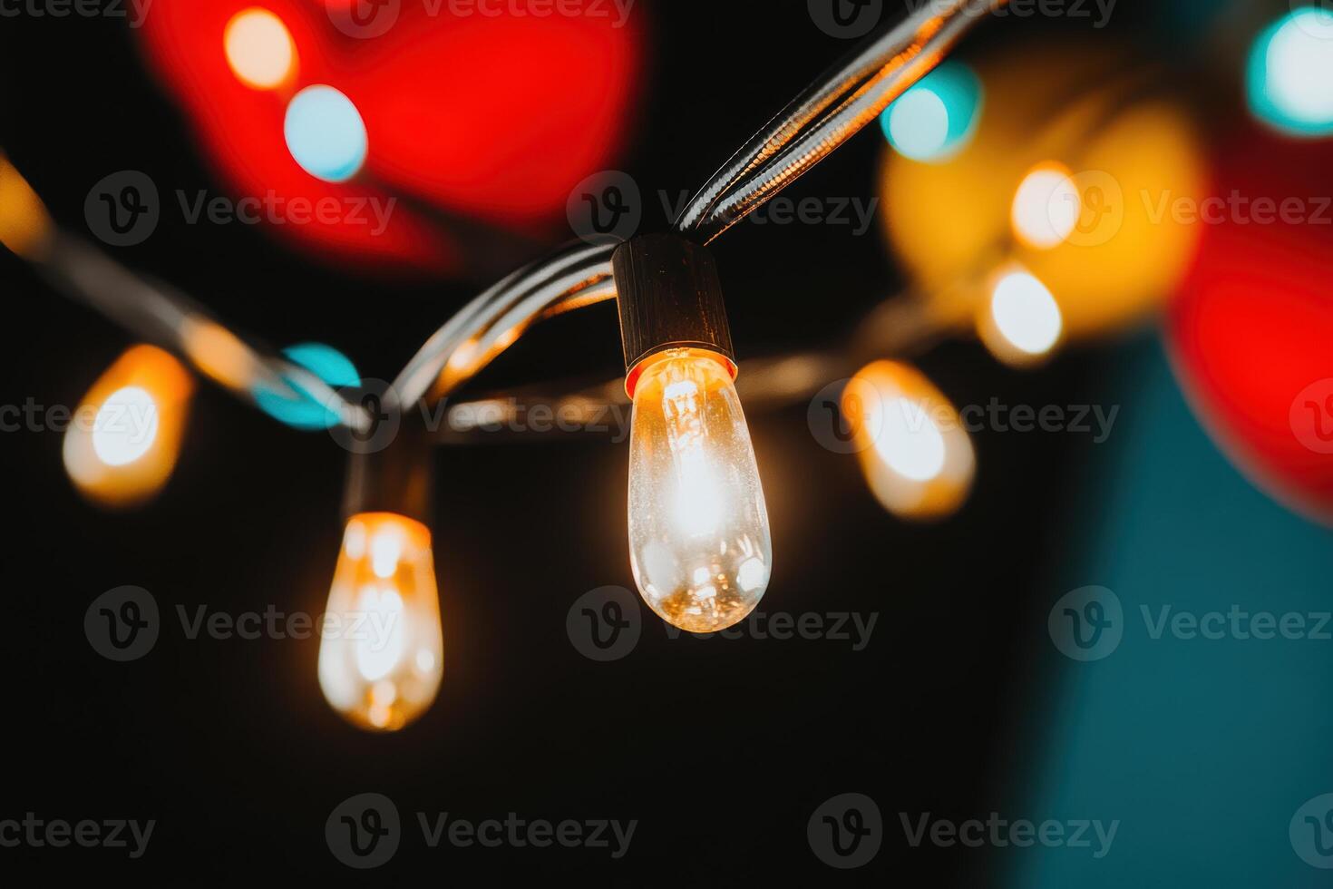 Decorative string lights illuminate a festive atmosphere in a dark setting at night photo