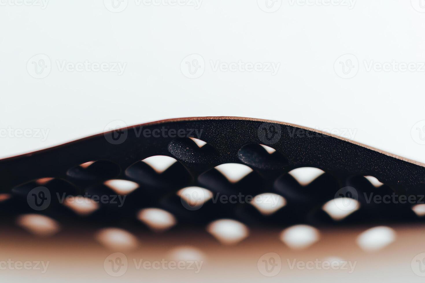 Innovative design of a curved black object showcasing an intricate surface pattern photo