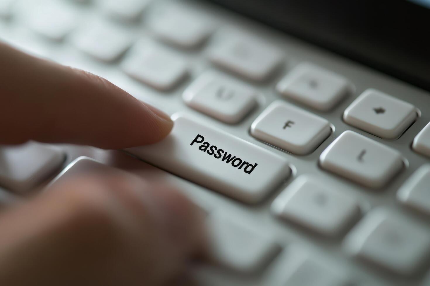 A person is typing on a keyboard with the word password photo