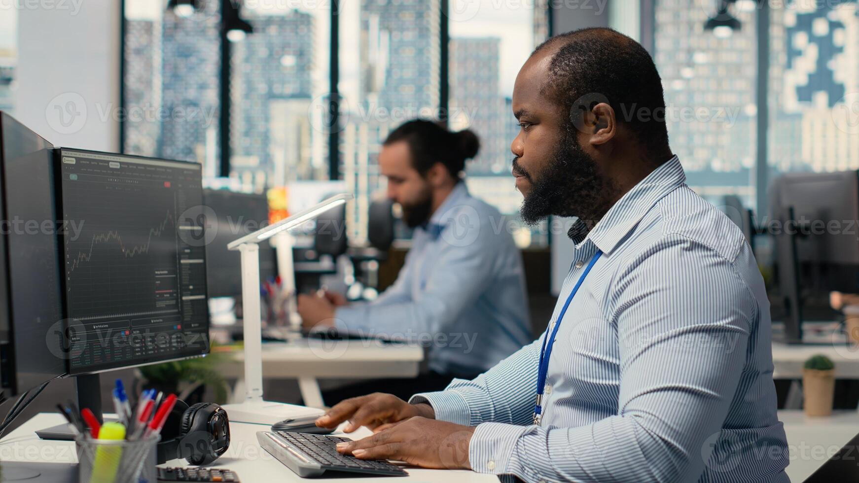 Trader frightened by security alert on PC after hacker uses exploit to penetrate systems. Brokerage company worker responds to cyberattack, protecting client account from unauthorized access photo