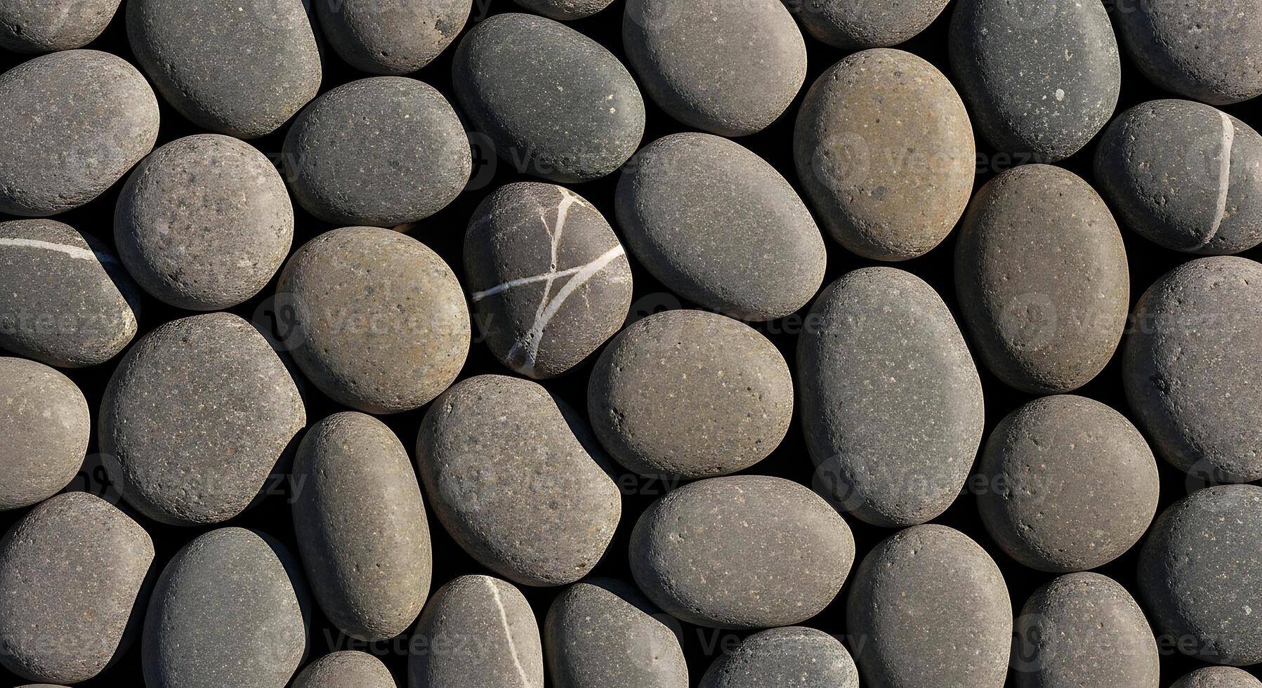 A Close-Up View Of Smooth, Rounded Grey Stones Arranged In A Natural Pattern. Perfect For Backgrounds, Textures, Or Design Elements. photo