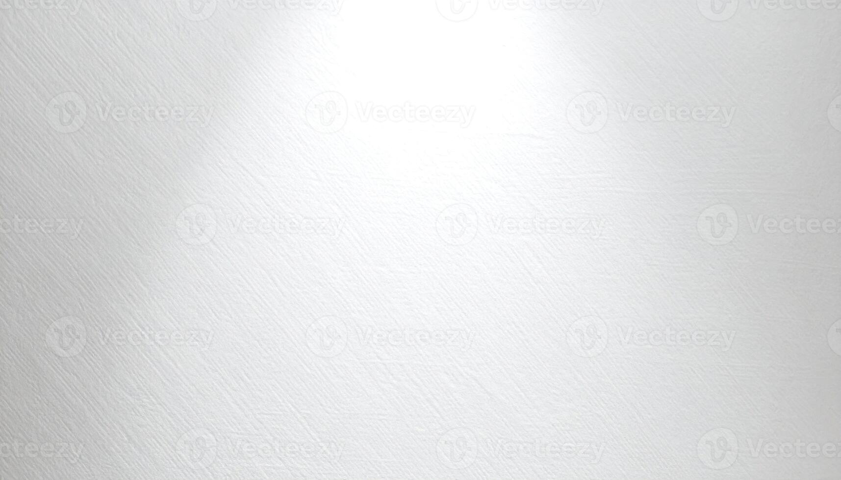 A close-up view of a smooth, textured white surface, illuminated by a directional light source. photo