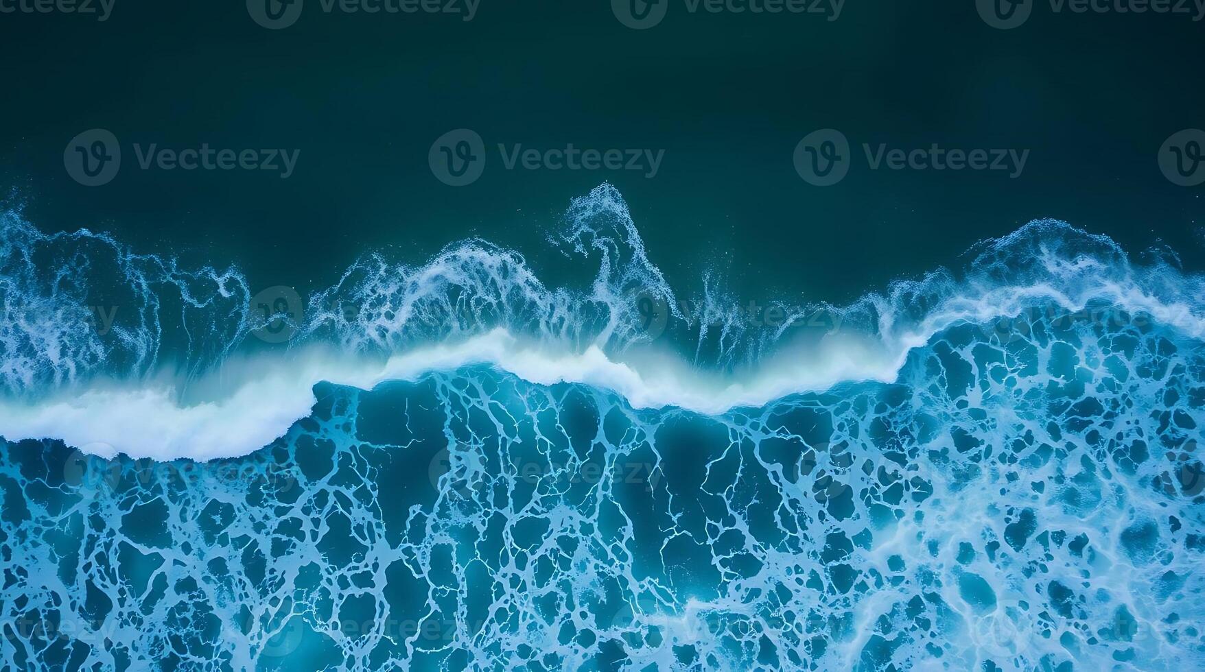 Stunning aerial view captures the dynamic power and mesmerizing beauty of crashing ocean waves with intricate foam patterns. photo