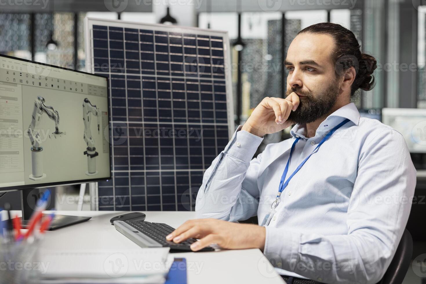 Engineer designs solar panels using CAD software, enhancing efficiency and reducing environmental impact. Green energy facility worker develops robotic arm systems for automated solar cells production photo