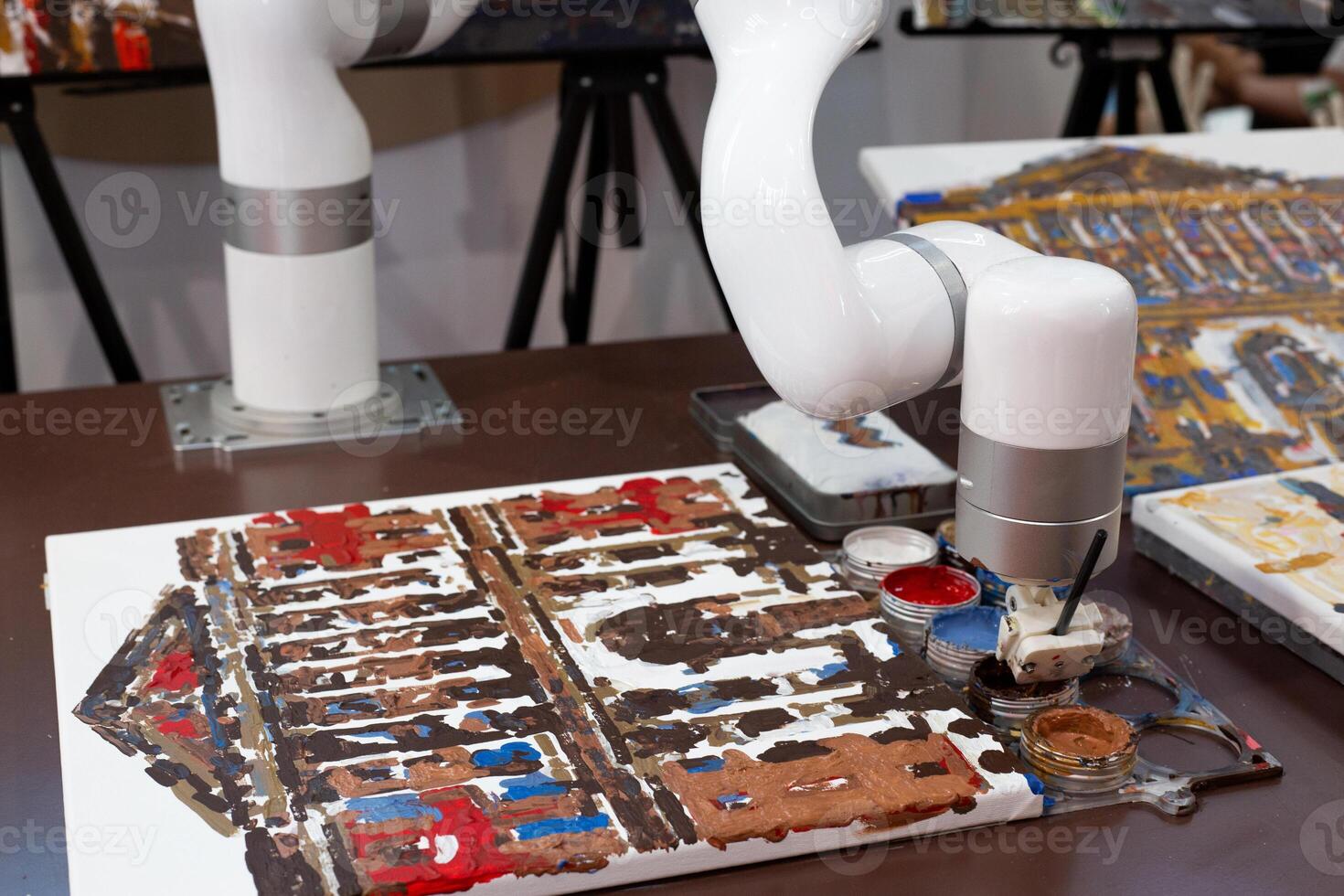 Robotic arm painting on canvas, symbolizing automation replacing human creativity. Representation of artificial intelligence competing with humans in art and design professions photo