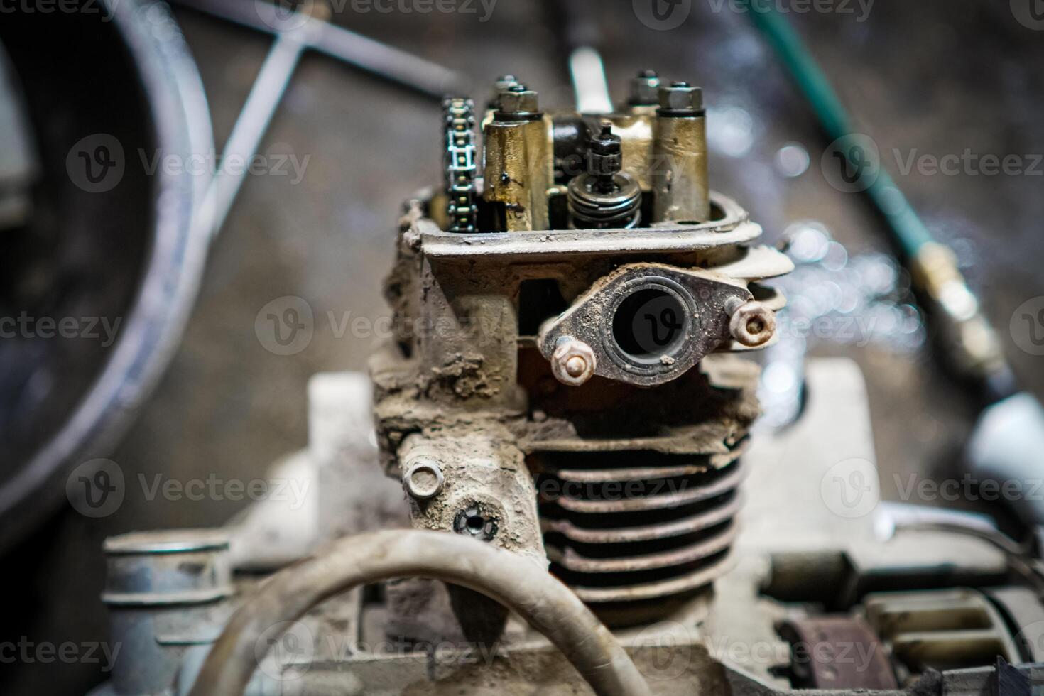 Close-Up of an Old Motorcycle Engine Component in a Workshop Setting photo