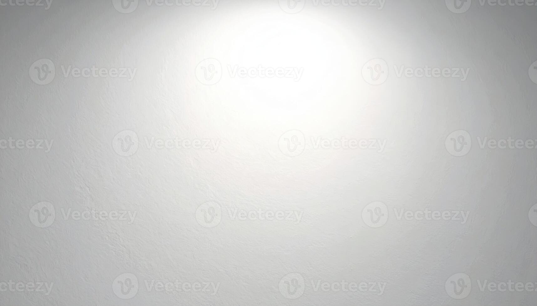 A plain, light gray wall texture, illuminated by a focused light source, showcasing subtle surface variations. photo