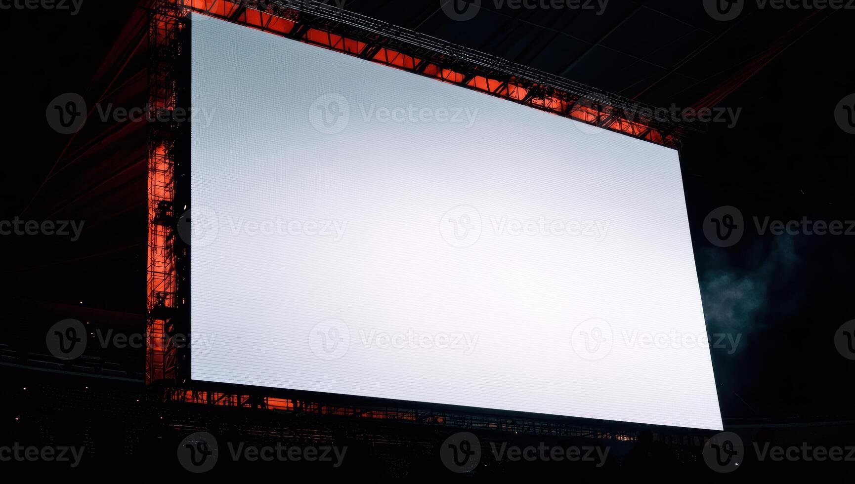 Large empty screen in modern stadium awaiting event in evening photo