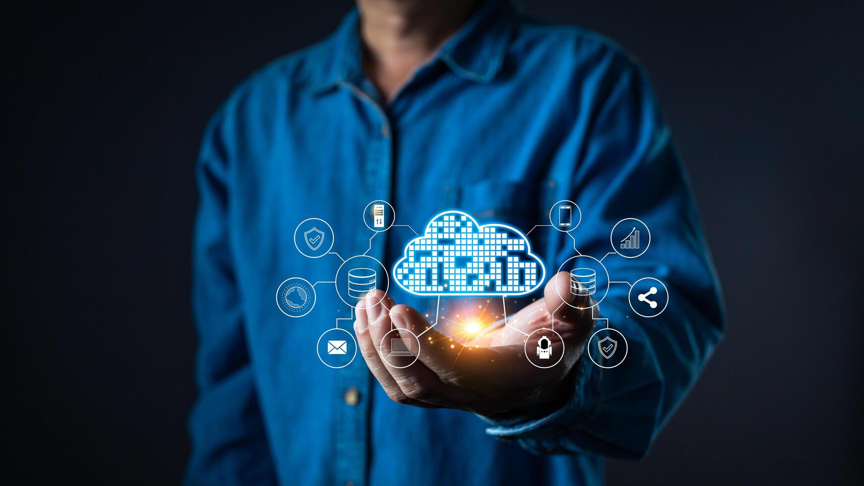 A person holds a glowing cloud computing system with digital icons representing cloud storage, security, networking, and data analytics. The futuristic tech interface symbolizes information systems. photo