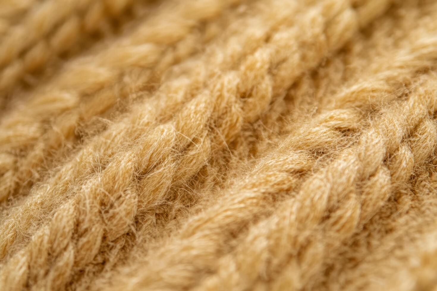 Close-up view of textured yellow knitted fabric showing intricate pattern photo