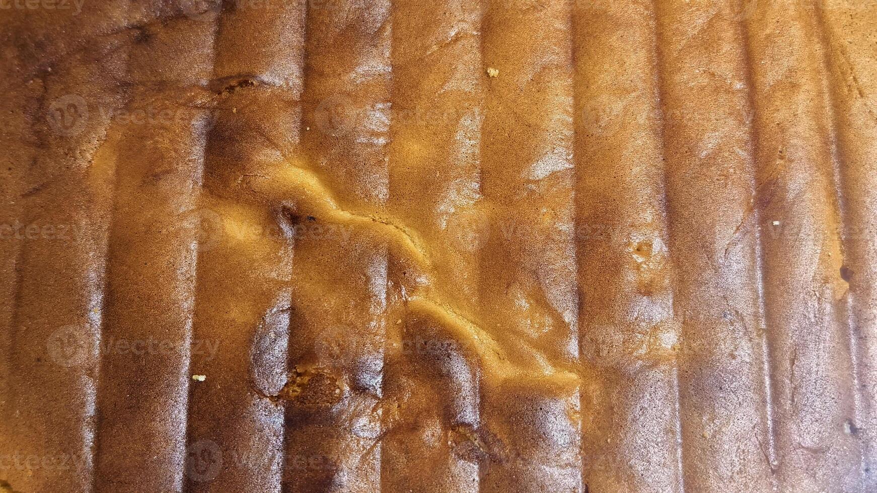 Golden Brown Baked Cake Texture with Ribbed Pattern and Wavy Highlight photo
