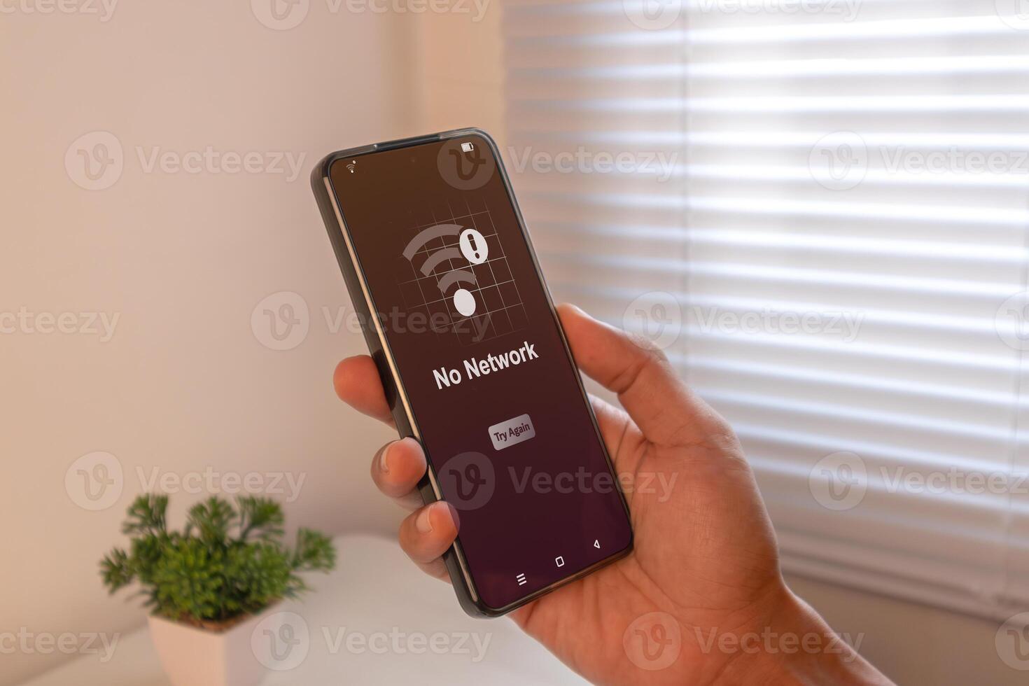 No network, No internet access or bad connection concept. Hand holding mobile phone with No Network notification. photo