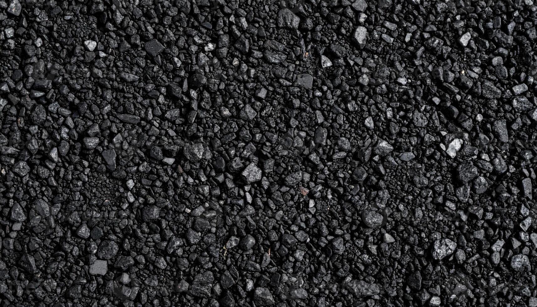 Close up asphalt micro aggregate polished patch neutral charcoal wallpaper background representing urban surface detail suitable for minimal design photo