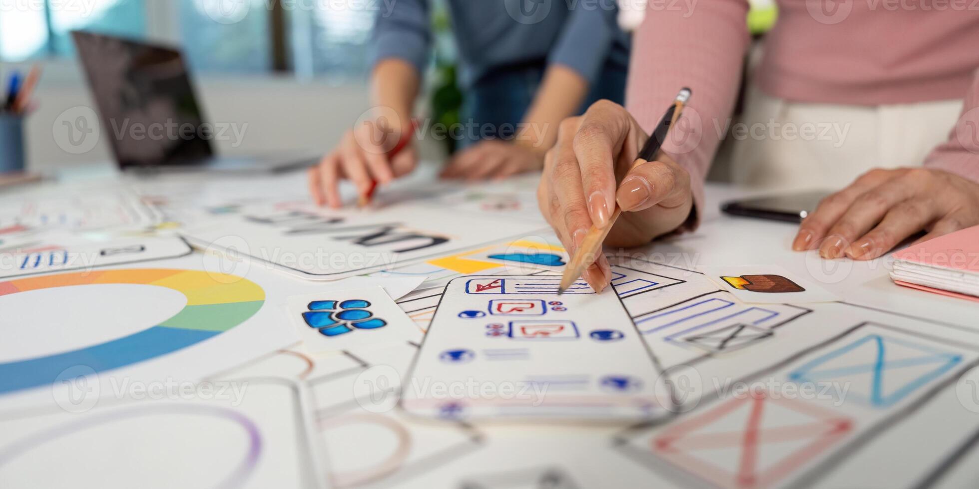 Hands on UX and UI Design. Team members sketching ideas and wireframes on a collaborative project. photo